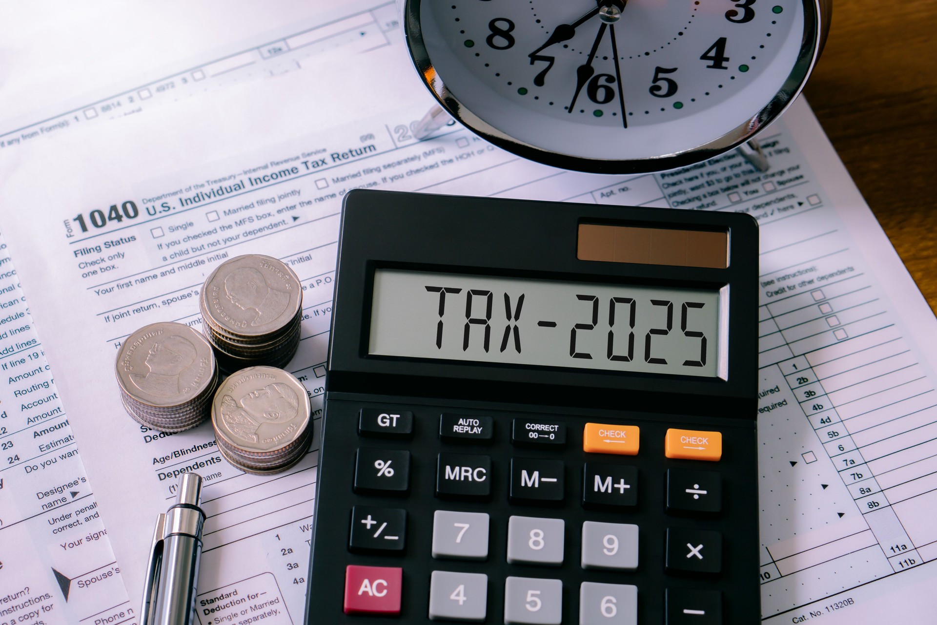 Word Tax 2025 on the calculator on documents.Income Statement. paying the tax rate. Taxation, taxes burden, savings and New Year Resolution.Business and tax concept.